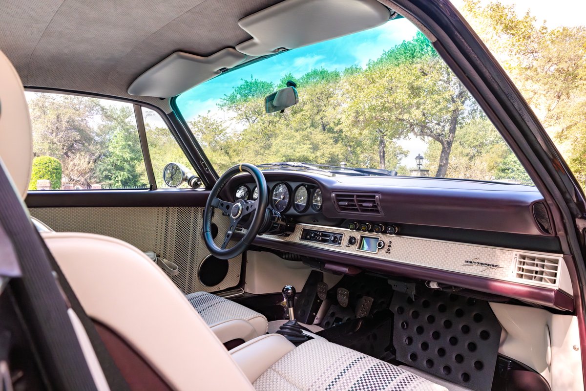 Aubergine 1990 Singer 911 interior, with racing seats, custom dash, and sport steering wheel.