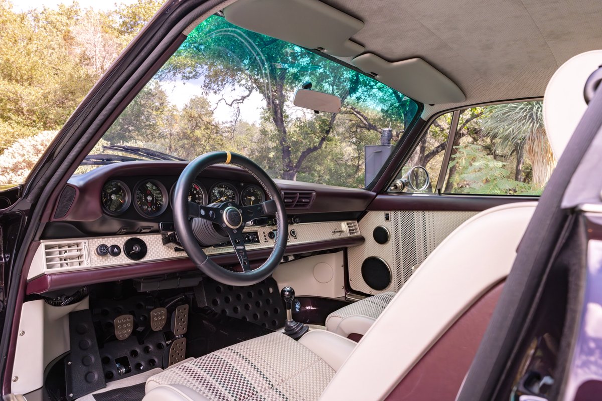 Singer 911 interior, aubergine metallic accents, vintage dashboard, and checkered seats.