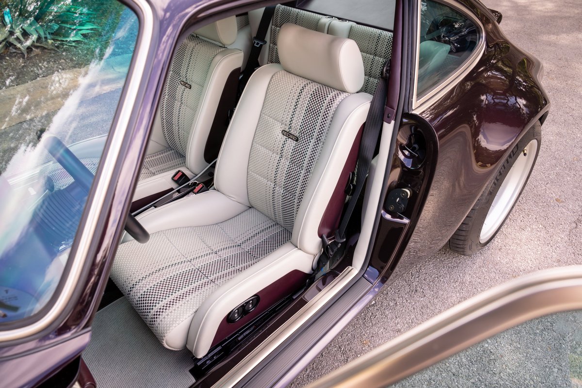 Aubergine metallic 1990 Singer Porsche 911 interior with Recaro seats and diamond-stitched trim.