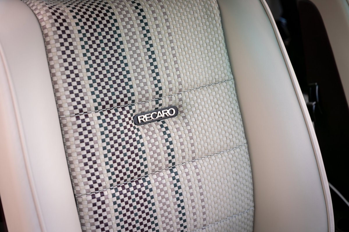 1990 Porsche 911 Singer in Aubergine Metallic features a Recaro seat with checkered fabric insert.