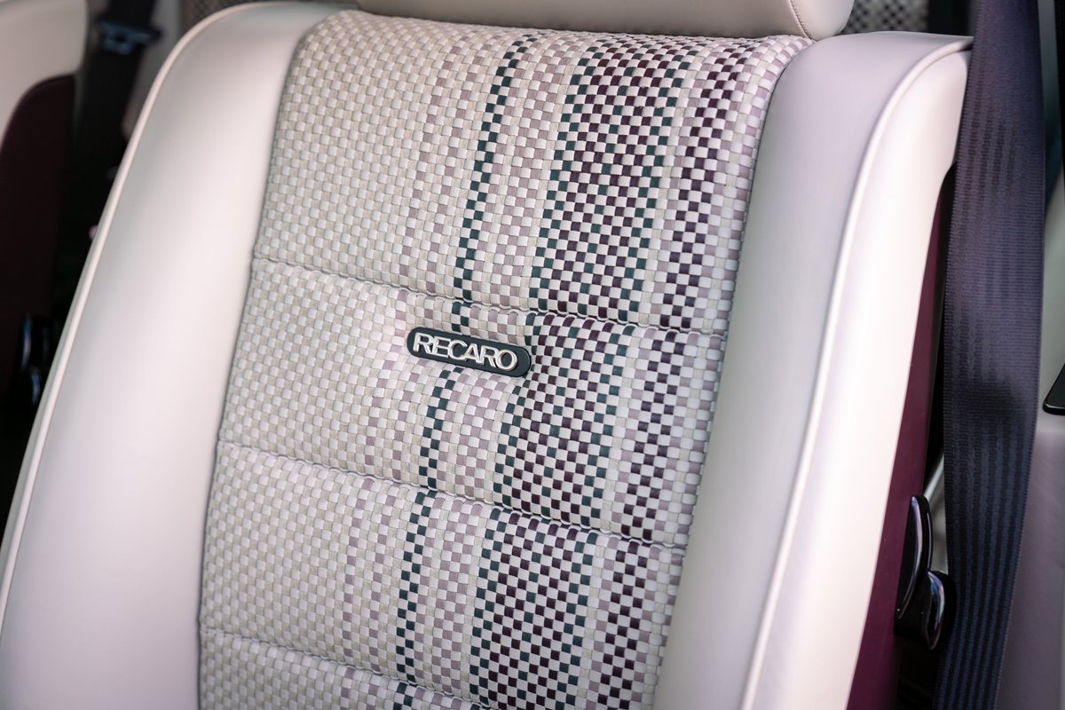 Aubergine metallic 1990 Singer Porsche 911 Recaro seat with checkered fabric and white trim.