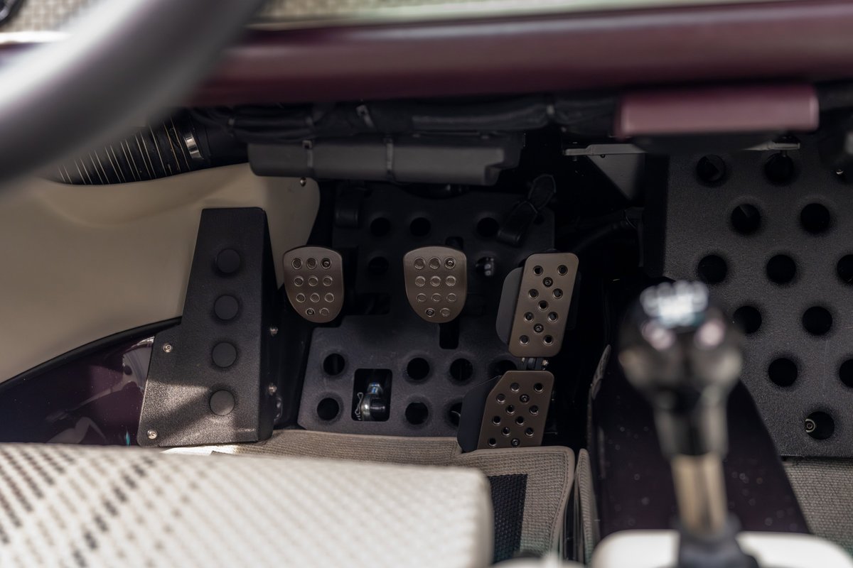 1990 Singer Porsche 911 dashboard with drilled pedals and gear shifter.