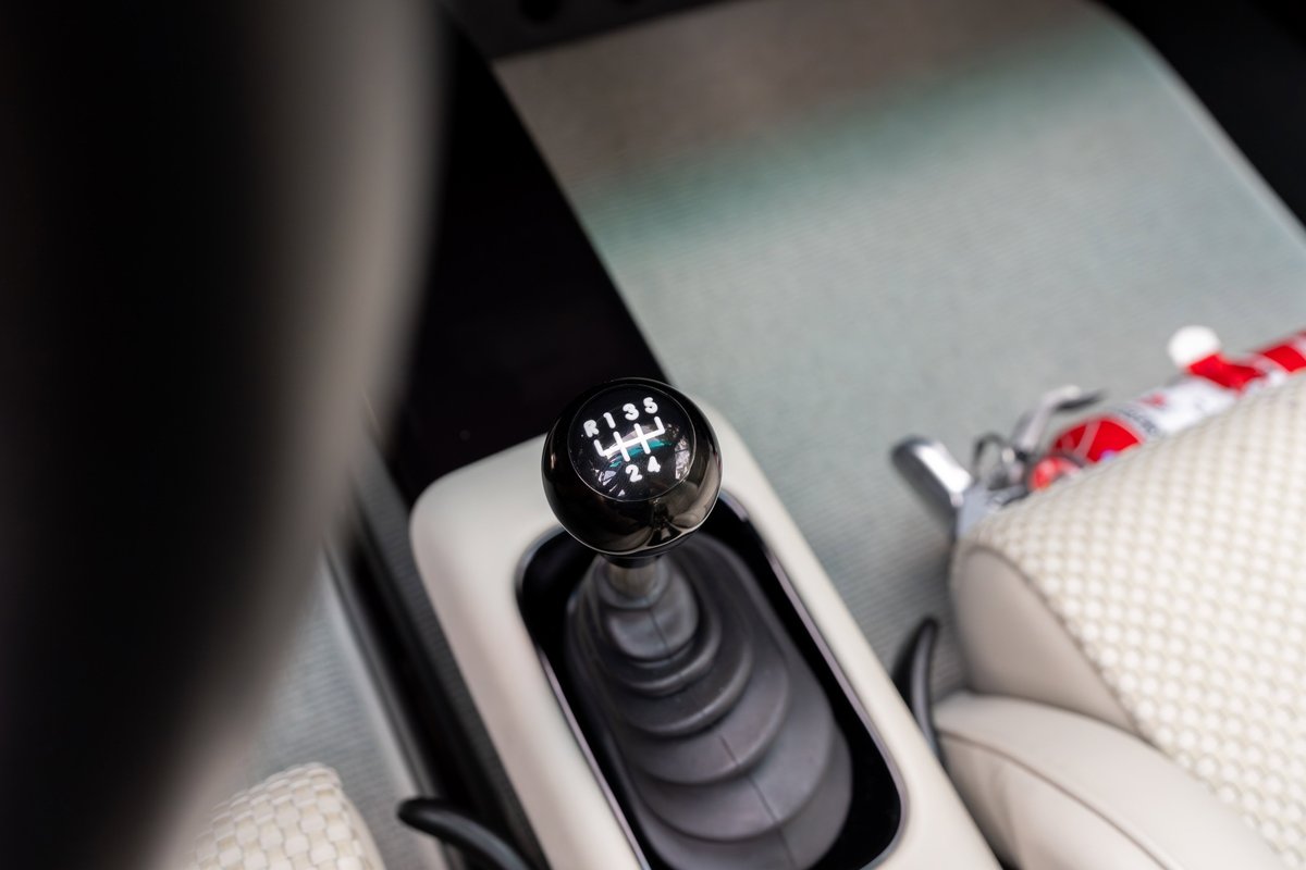 Interior shot of a 1990 Singer Porsche 911 with a 6-speed manual shifter.