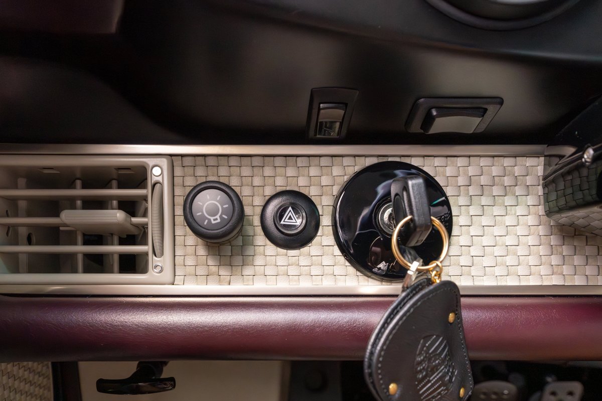 1990 Singer Porsche 911 Aubergine Metallic interior showing ignition, air vent, and hazard light button.
