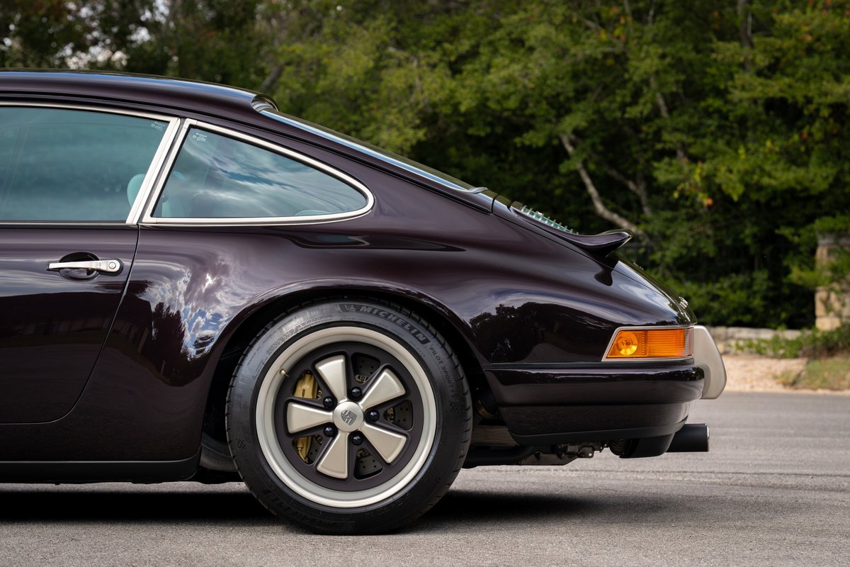 Aubergine Metallic 1990 Singer 911 rear quarter with Fuchs-style rims.
