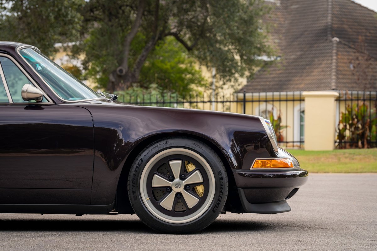 Aubergine metallic 1990 Singer 911 front fender and Fuchs rims with gold calipers.