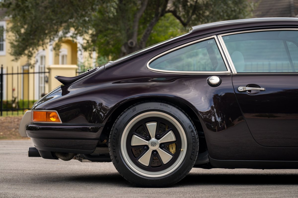 Aubergine metallic 1990 Singer 911, rear quarter view, Fuchs wheels, ducktail spoiler.