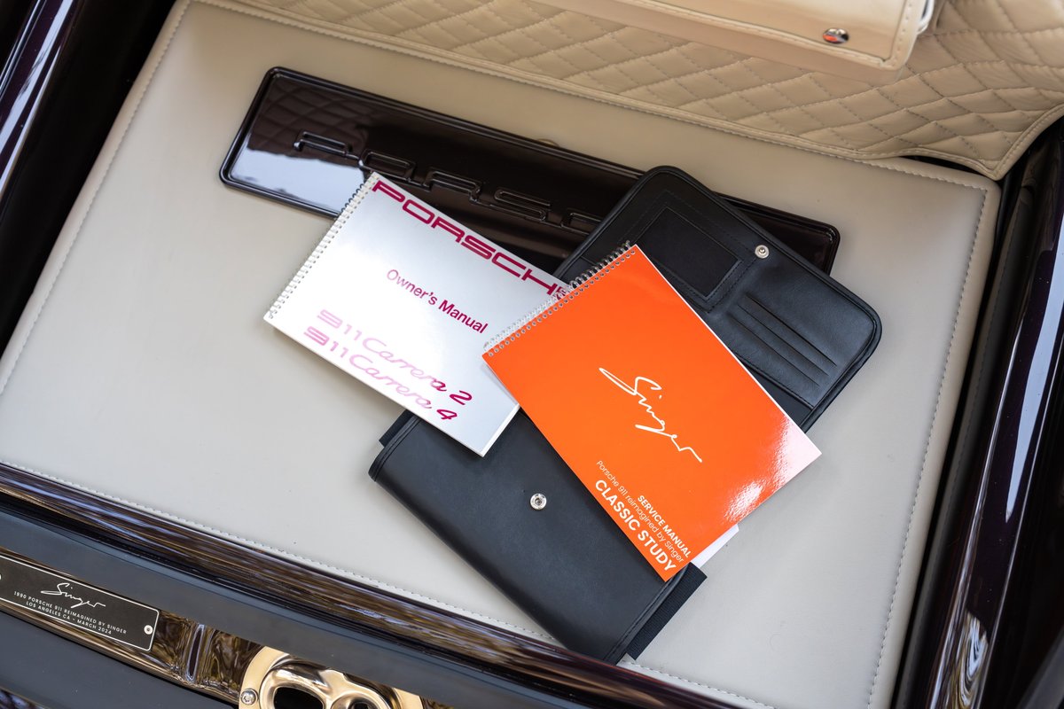 Singer Porsche 911 Aubergine Metallic owner's manual and service book inside car.