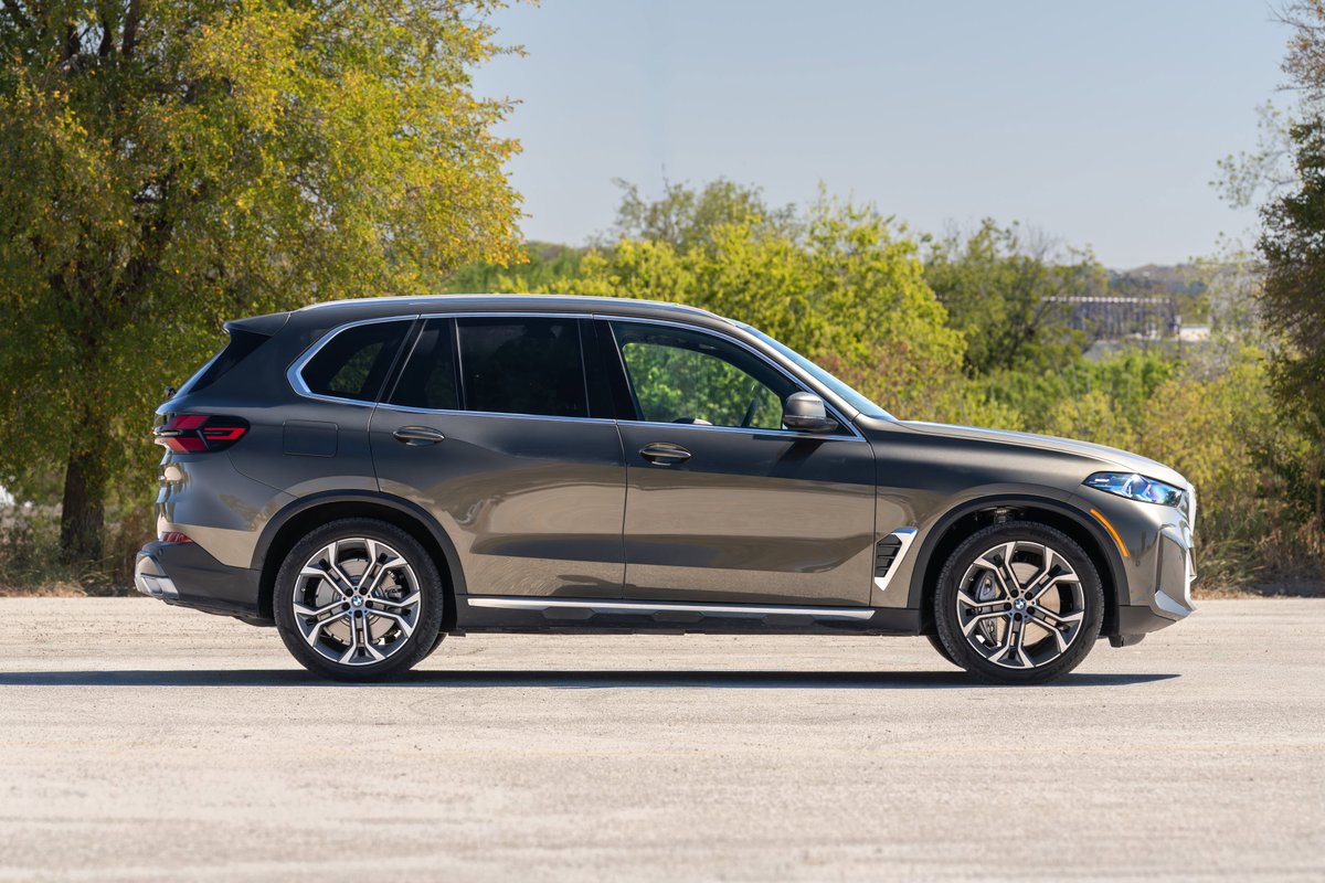 2026 BMW X5 in Manhattan Green features large alloy rims and chrome trim.