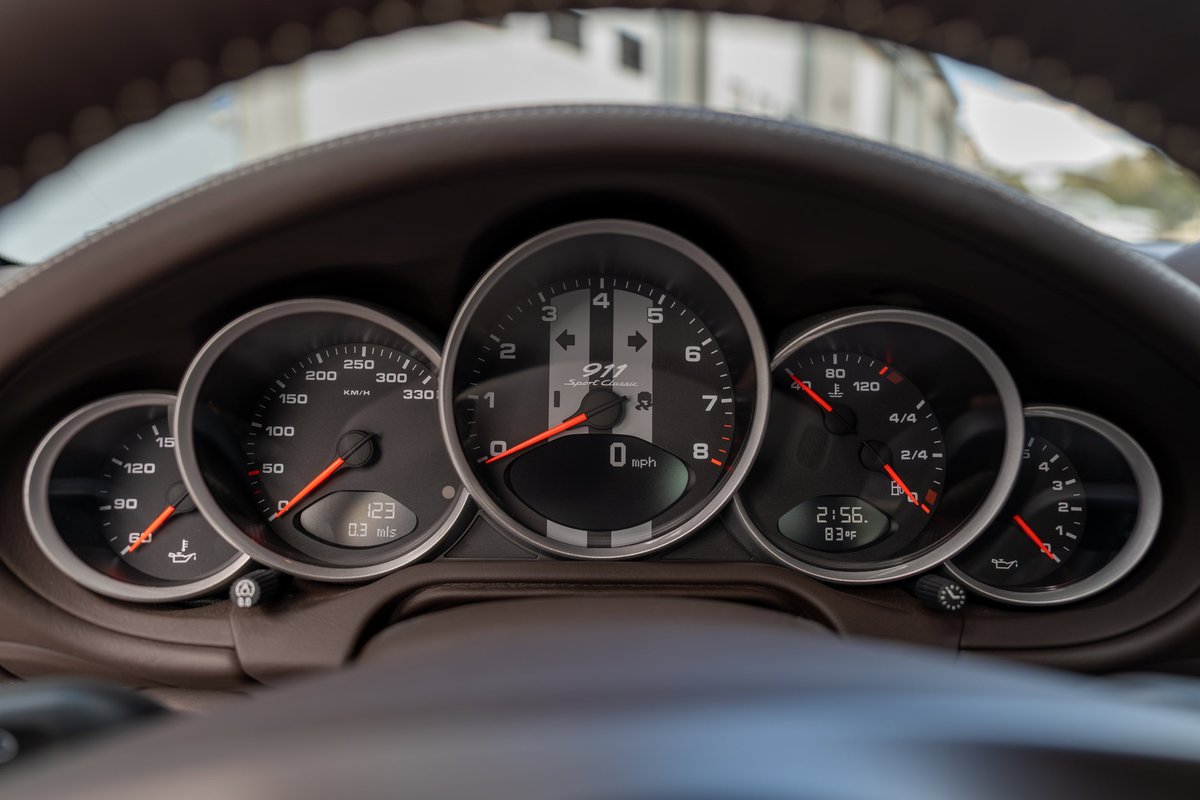 Interior of a 2010 Porsche 911 Sport Classic, showing a classic five-dial instrument cluster.