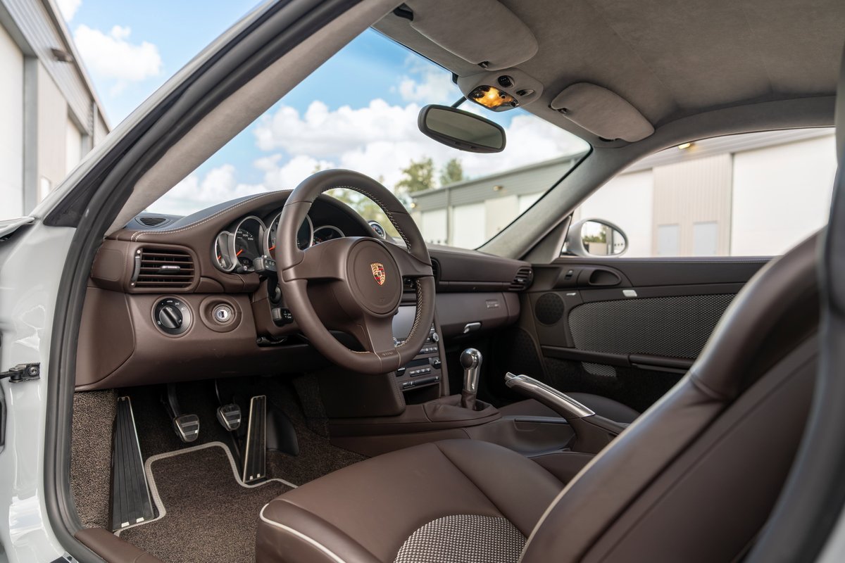 2010 Porsche 911 Sport Classic interior. Brown leather trim, sport pedals, manual shifter.