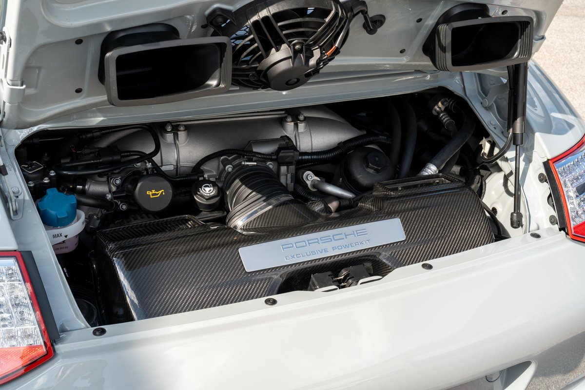 2010 Porsche 911 Sport Classic engine bay with carbon fiber intake cover.
