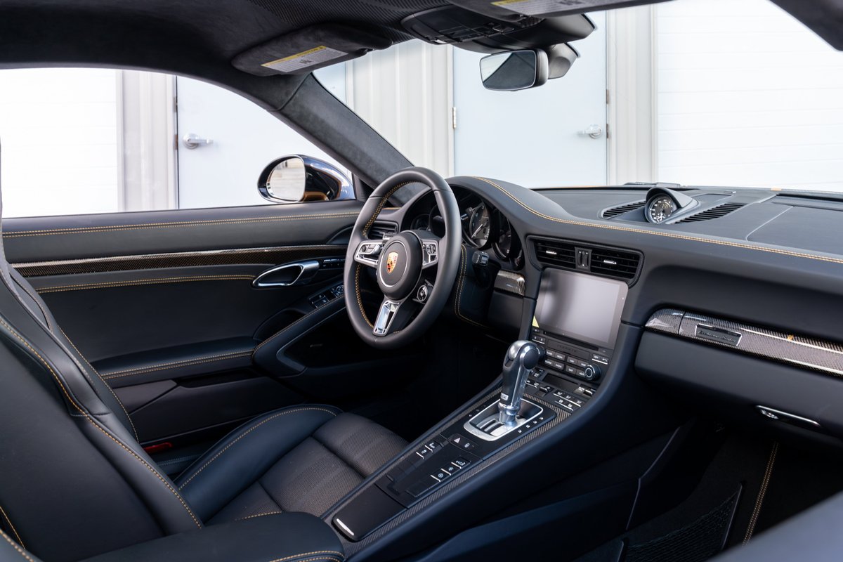 2018 Porsche 911 Turbo S Exclusive Series interior with black leather and yellow stitching.