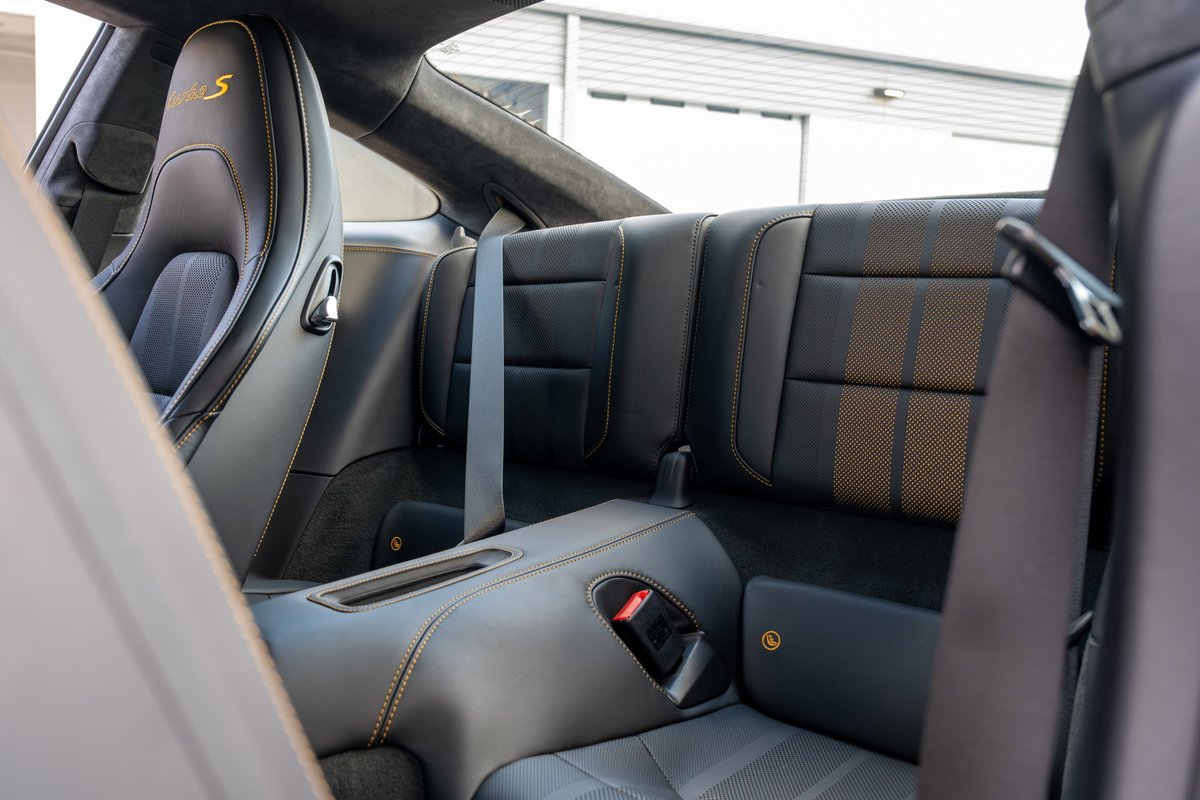 2018 Porsche 911 Turbo S Exclusive Series interior, black leather seats with gold stitching and accent stripes.