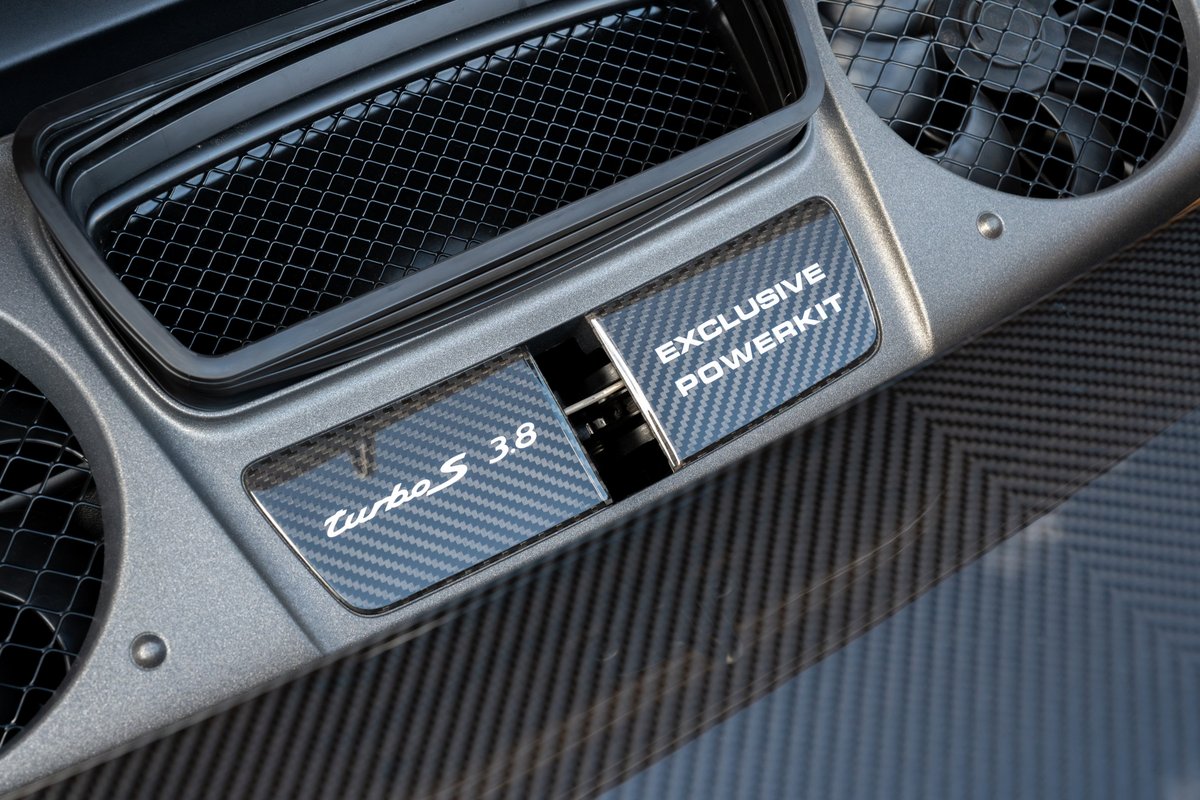Porsche 911 Turbo S Exclusive Series carbon fiber trim with "Turbo S 3.8" and "Exclusive Powerkit" badging.