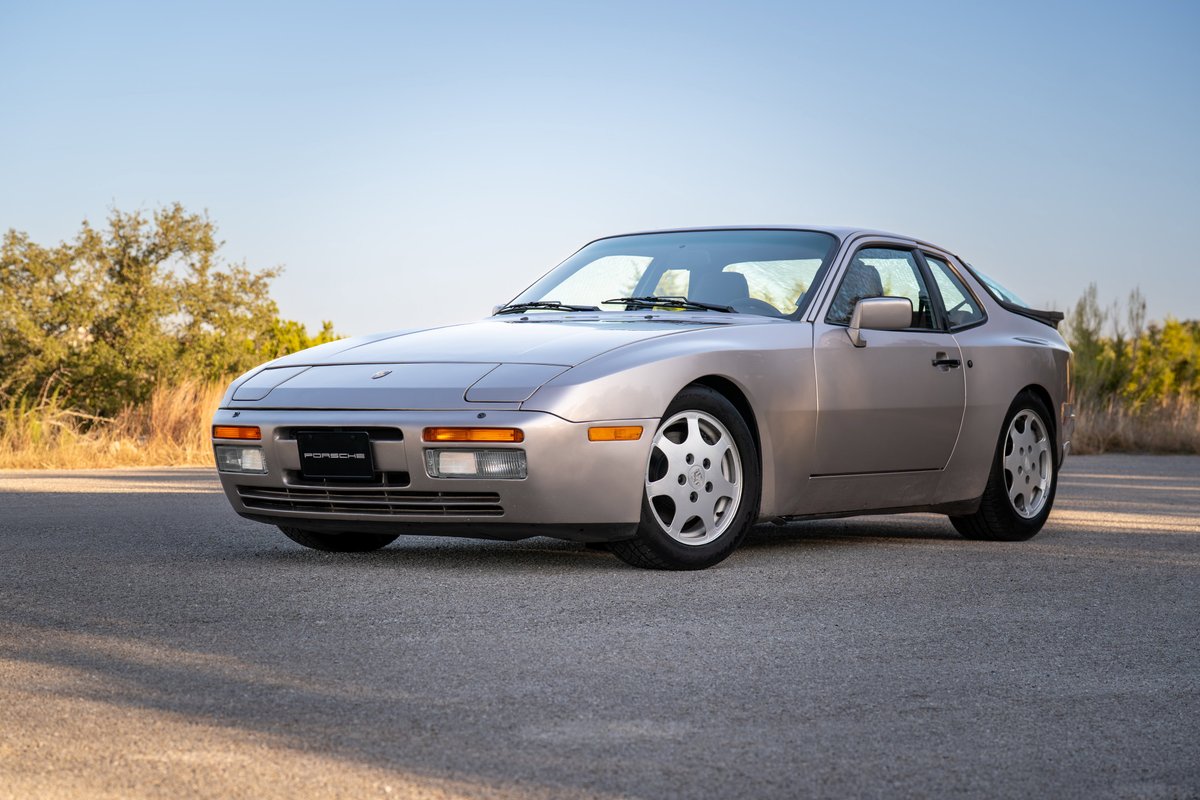 A silver 1987 Porsche 944 Turbo S with five-spoke alloy rims and a rear spoiler.
