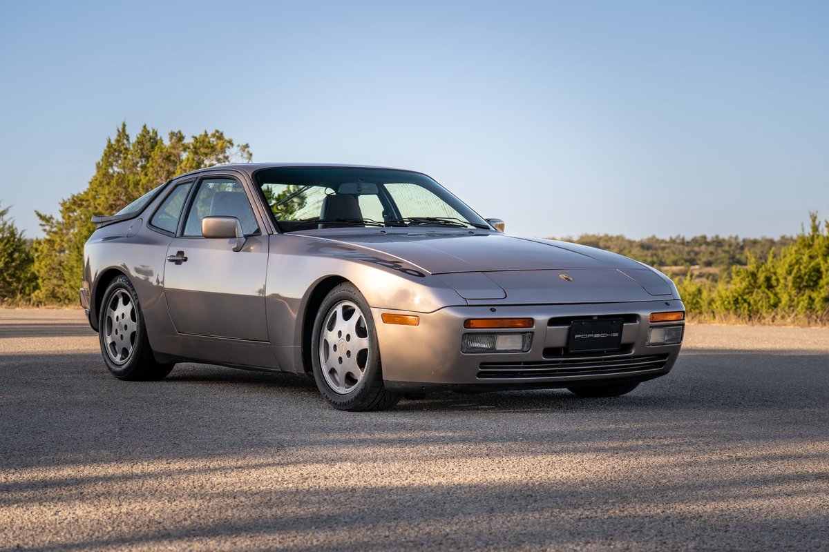 Silver 1987 Porsche 944 Turbo S with Fuchs rims, parked outdoors.