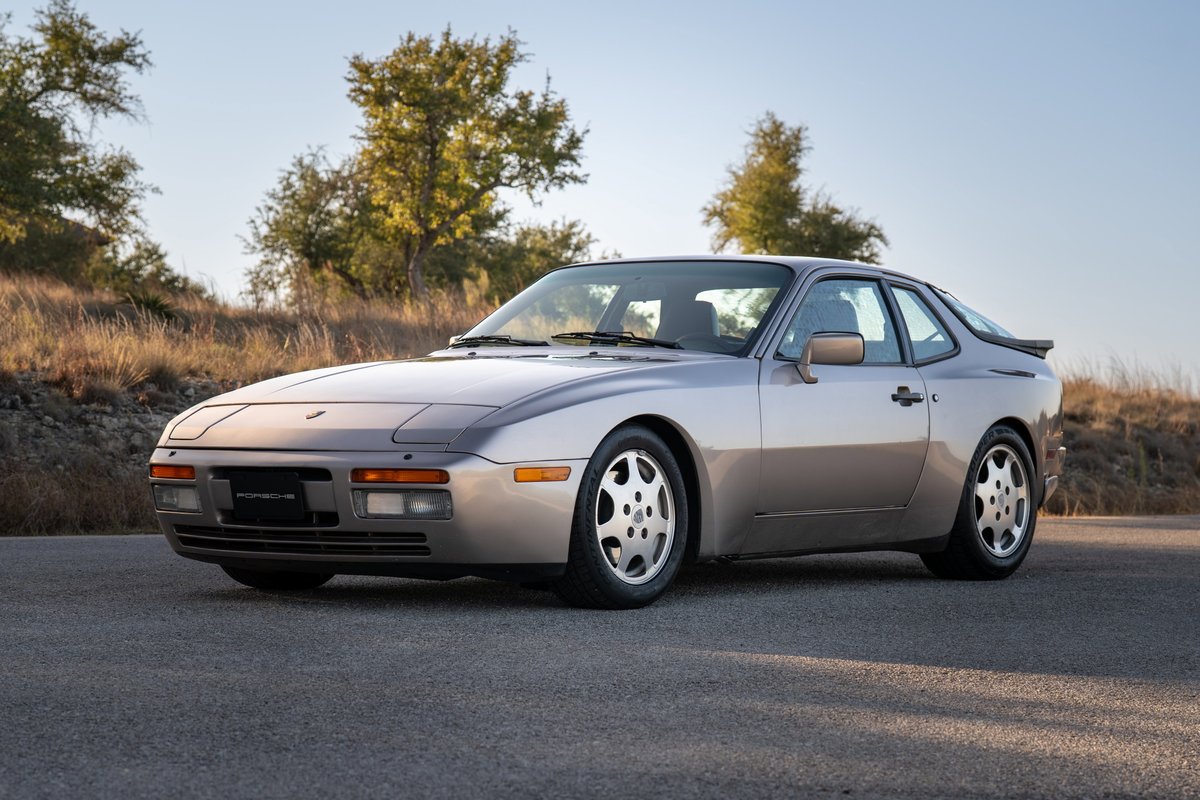1987 Porsche 944 Turbo S in silver. Features classic phone dial rims and a rear spoiler.