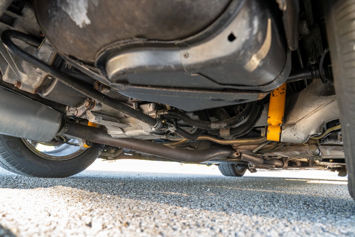 Underbody view of a 1987 Porsche 944 Turbo S. Features yellow shocks and exhaust system.