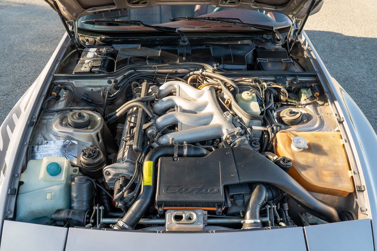 Silver Rose 1987 Porsche 944 Turbo S engine bay with polished intake manifold.