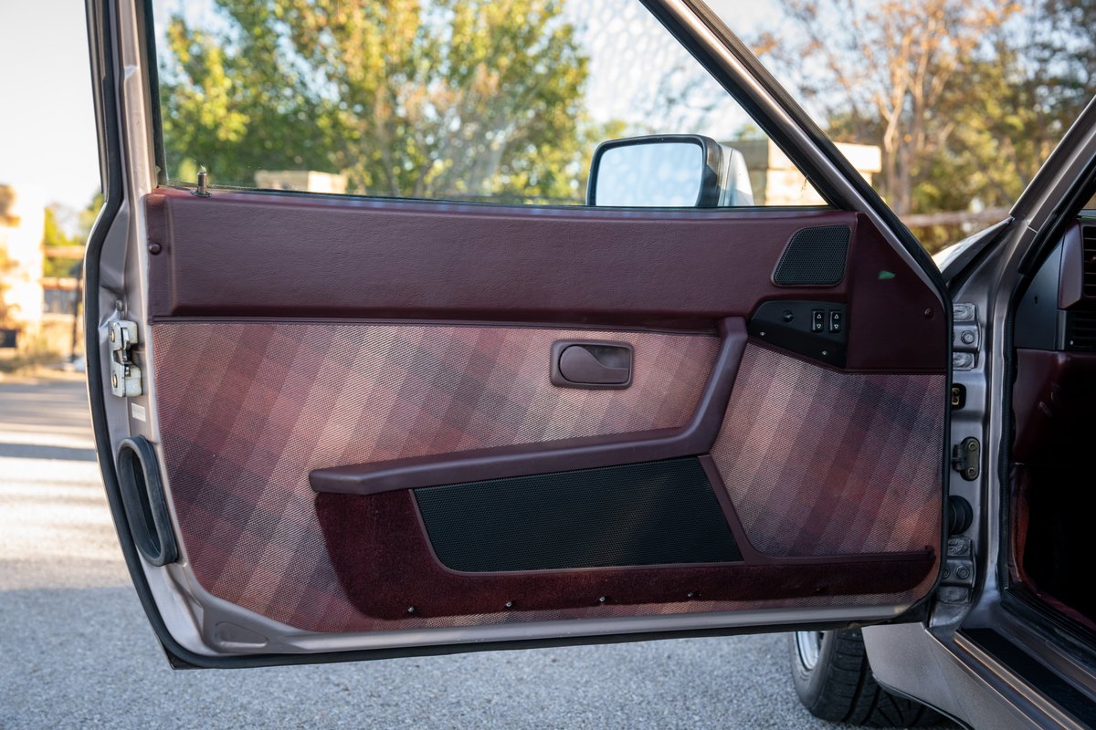 1987 Porsche 944 Turbo S door panel with plaid fabric insert and burgundy trim.