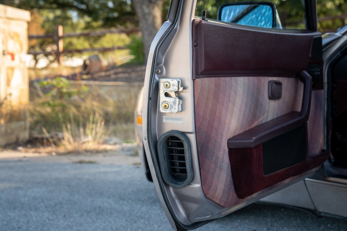 1987 Porsche 944 Turbo S door panel with burgundy trim and patterned fabric.