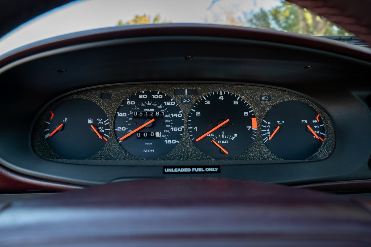 1987 Porsche 944 Turbo S gauge cluster with orange needles on a silver face.