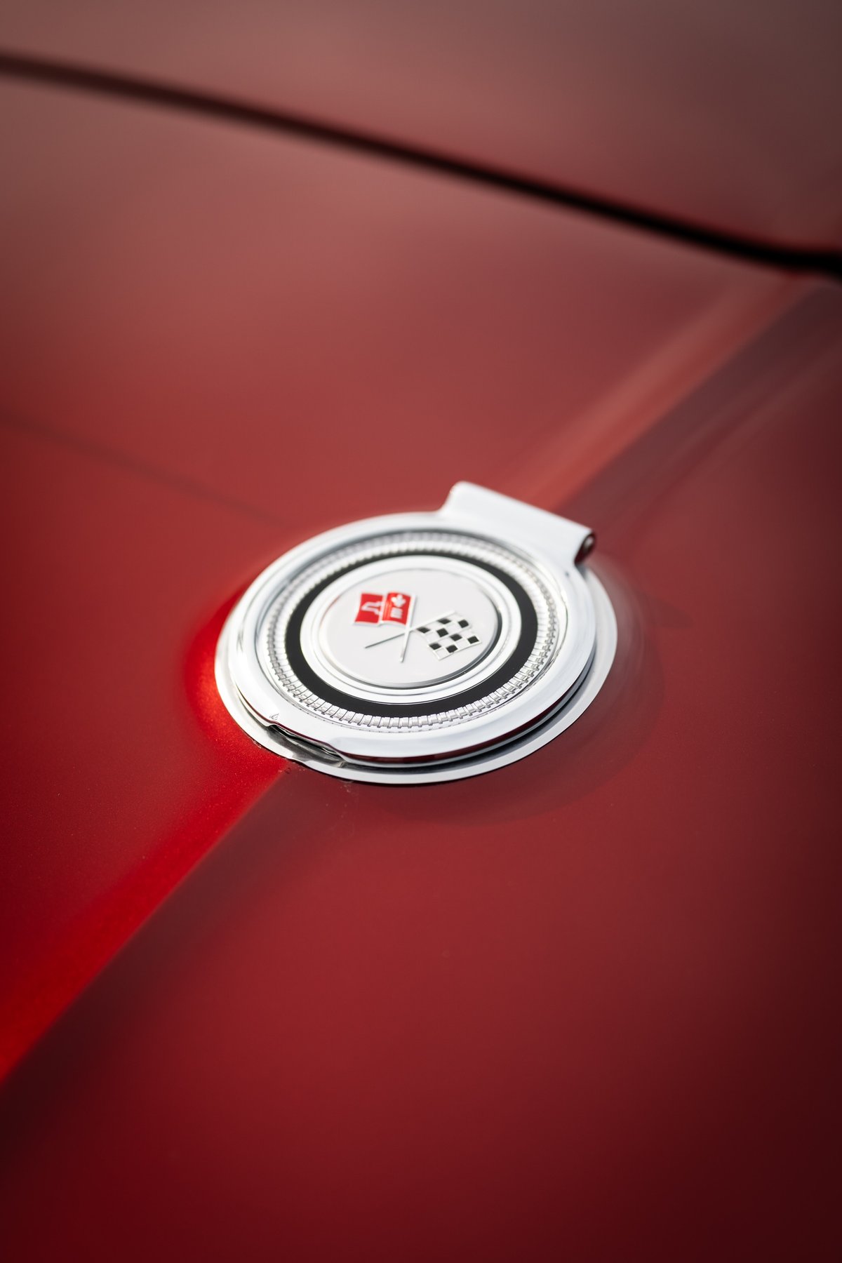 Corvette Stingray emblem on red paint.