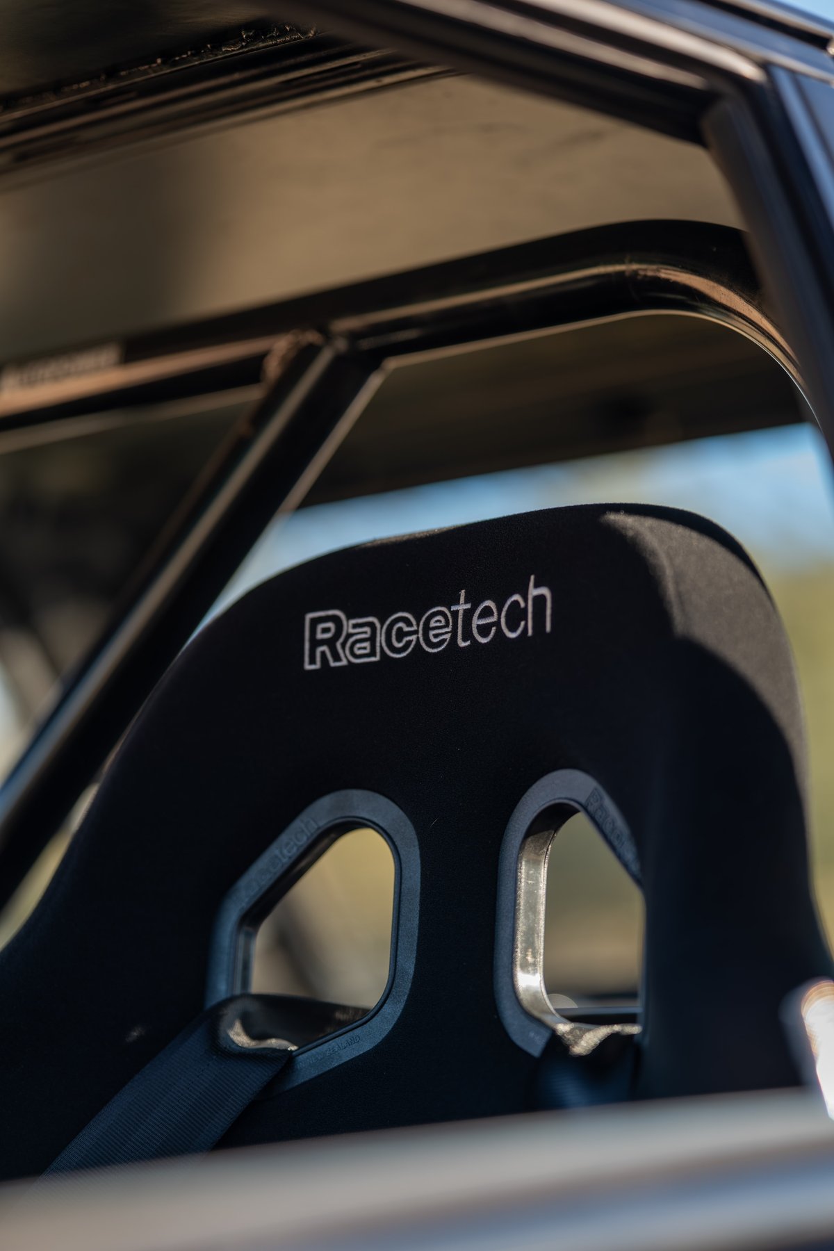 Black 1989 BMW 325is with a Recetech racing seat and roll cage.