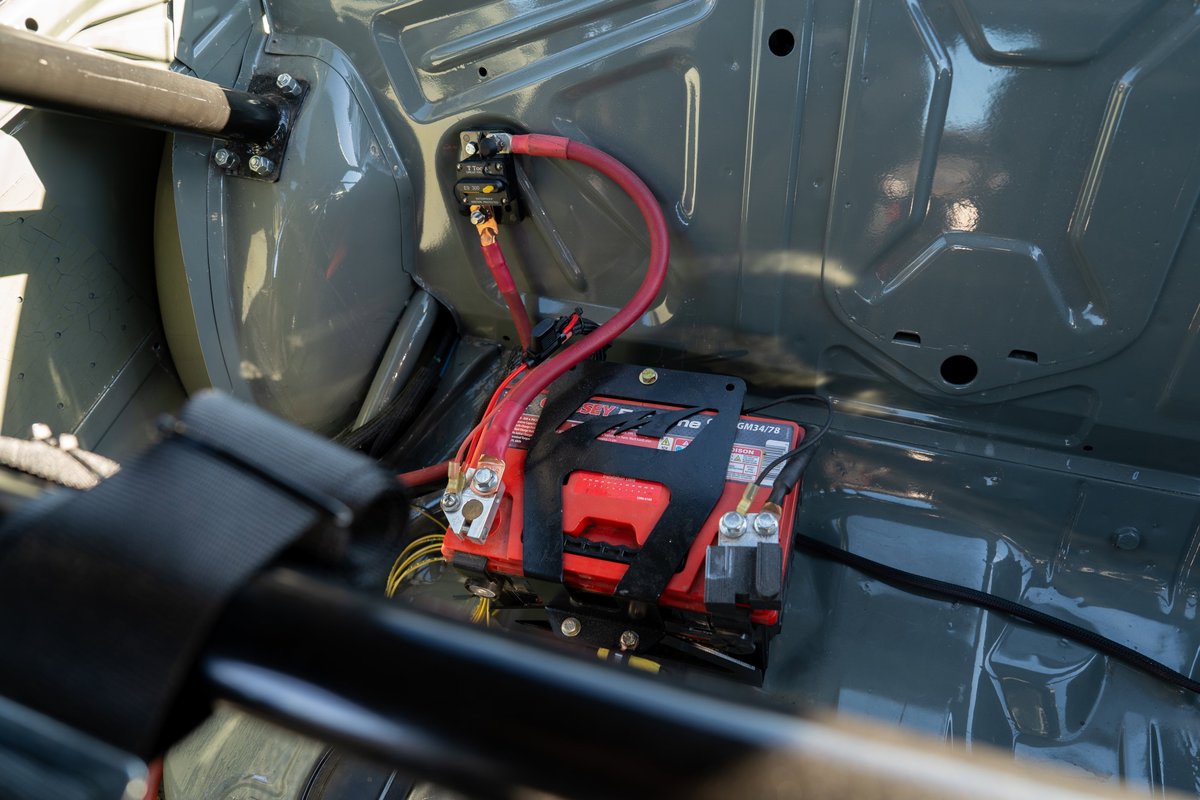 1989 BMW 325is LS1 swap battery relocation with red terminals and roll cage.