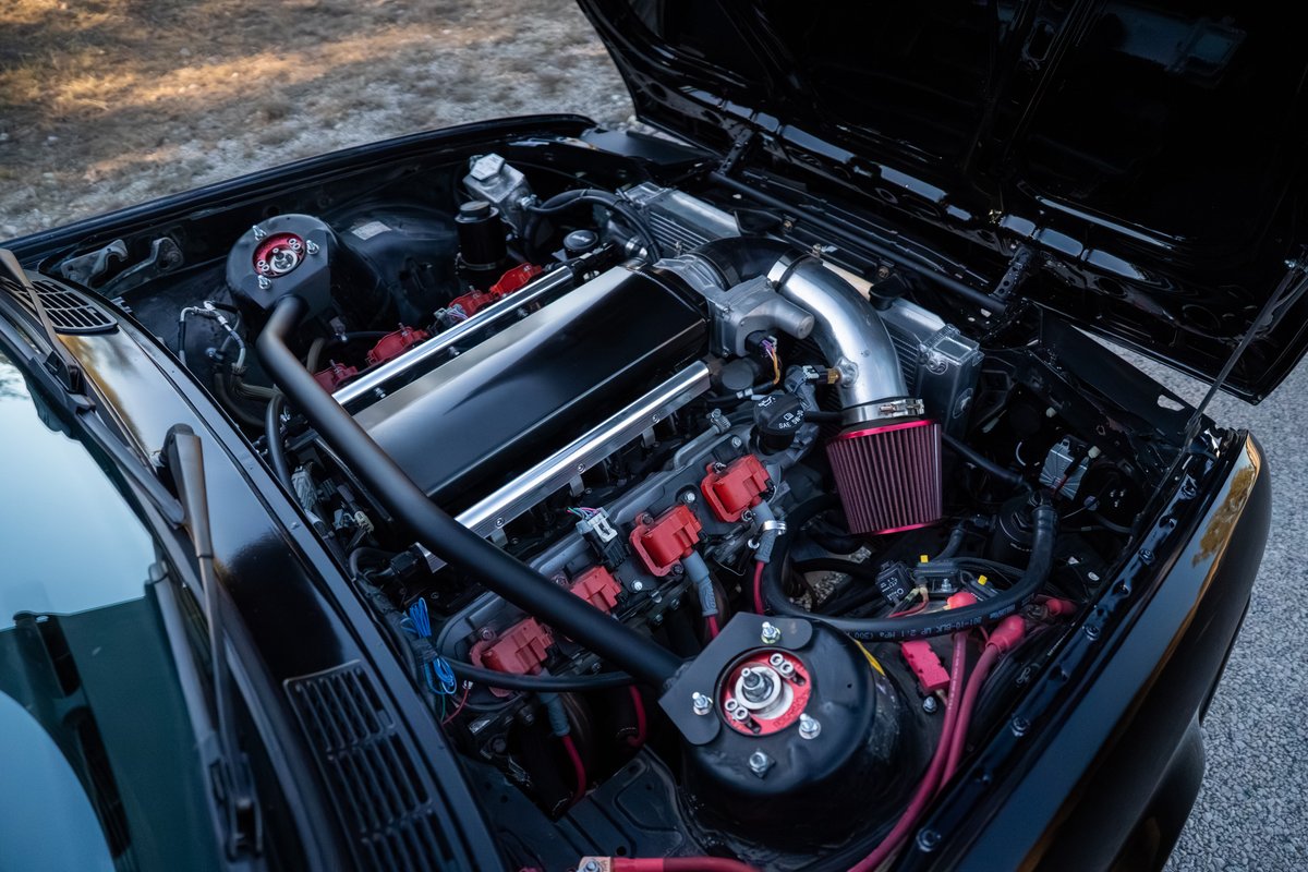 Black 1989 BMW 325is with LS1 engine swap, custom intake and red coil packs.