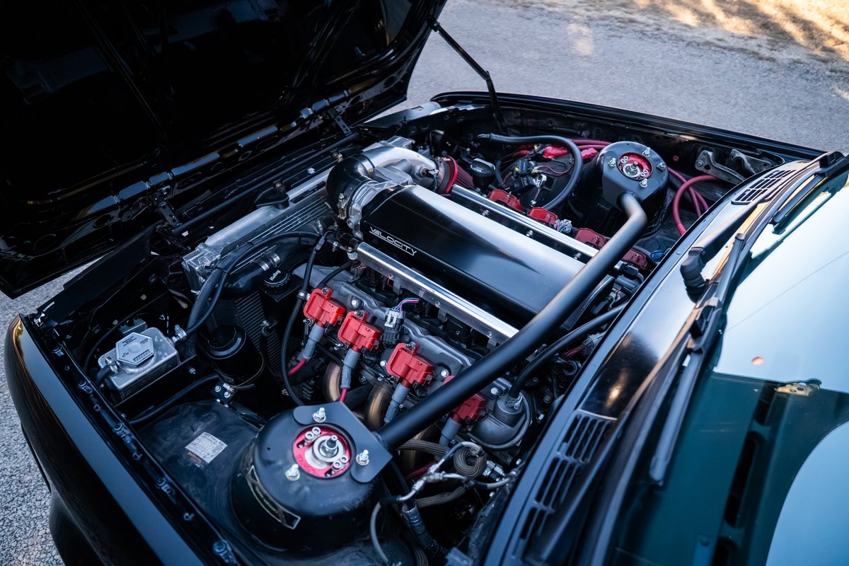 Black 1989 BMW 325is with LS1 V8 engine, custom intake manifold, and red coil packs.