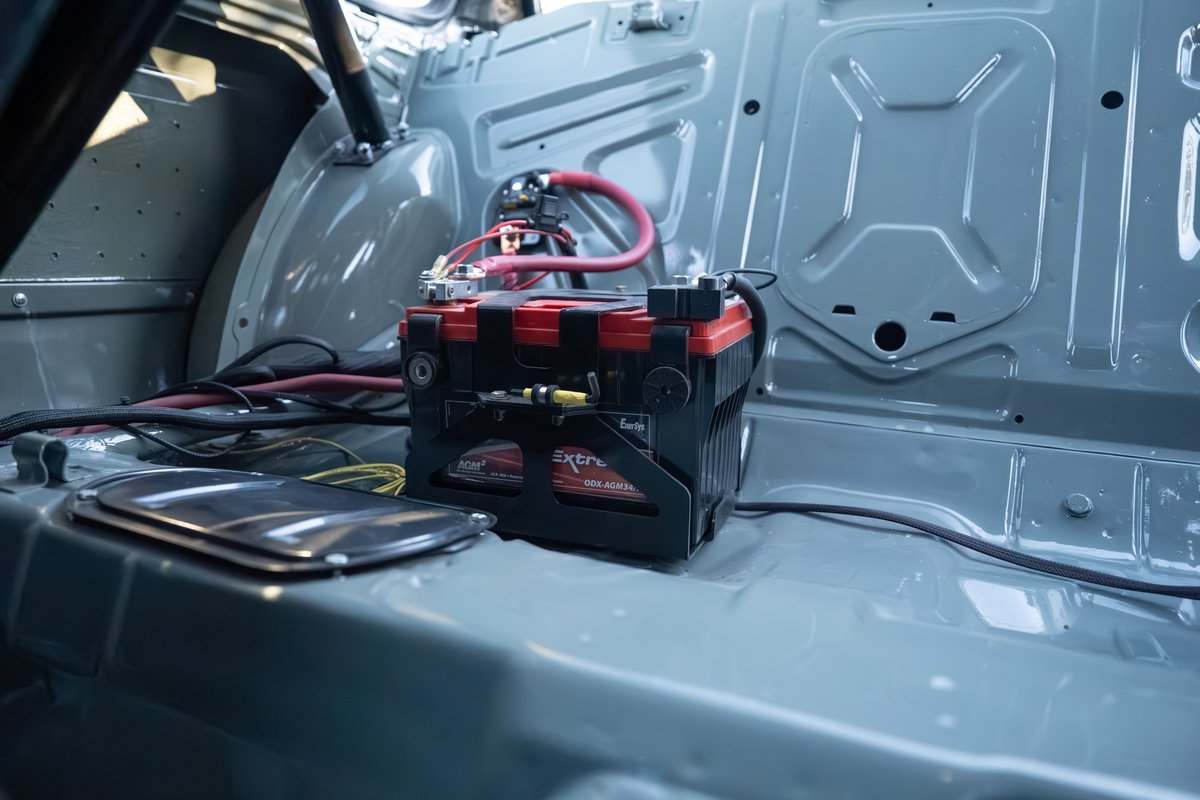 1989 BMW 325is with an aftermarket battery and wiring in the rear.