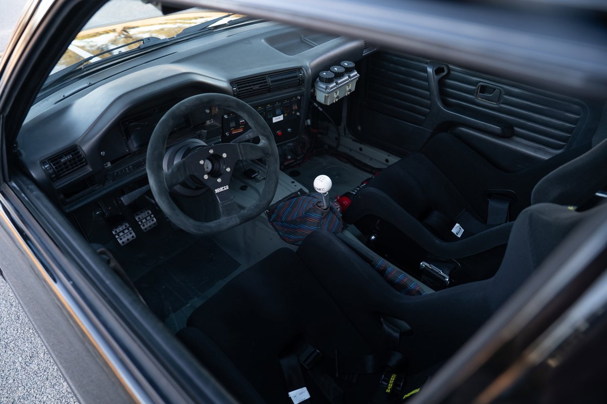 1989 BMW 325is LS1 interior: black racing seats, Sparco wheel, and shift knob.