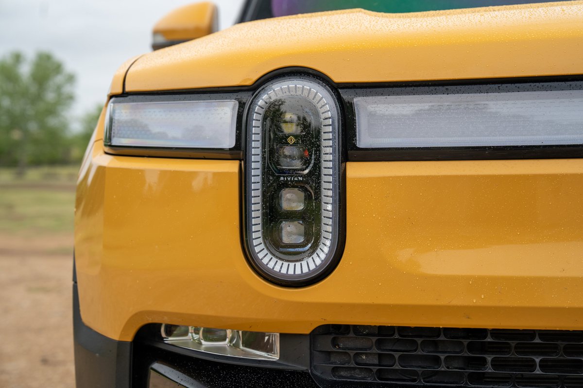 Yellow 2022 Rivian R1T front fascia with distinctive oval LED headlight design.