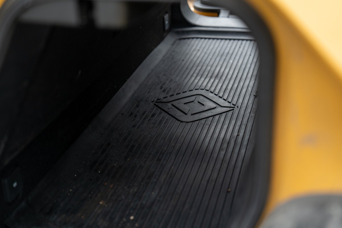 Yellow Rivian R1T pickup truck frunk liner with embossed Rivian logo.