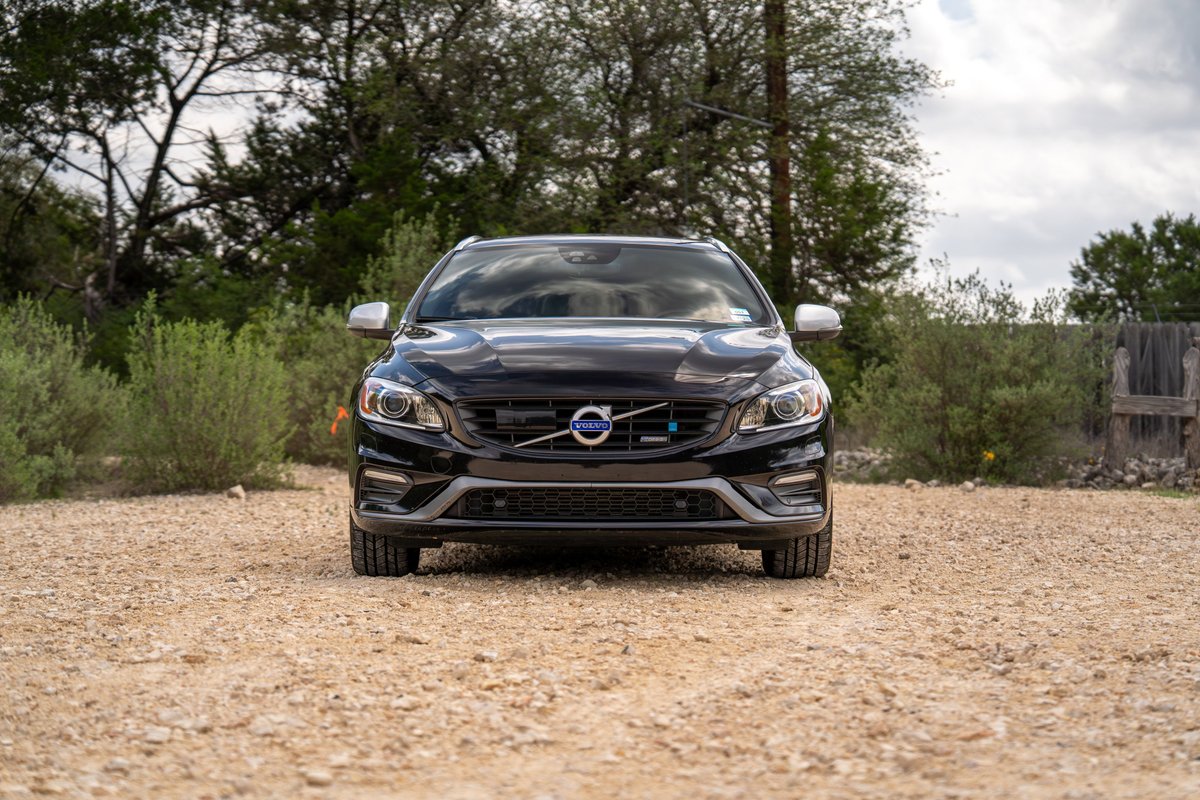 Front view of a black 2015 Volvo V60 R-Design Polestar. Features silver trim and a distinctive grille.