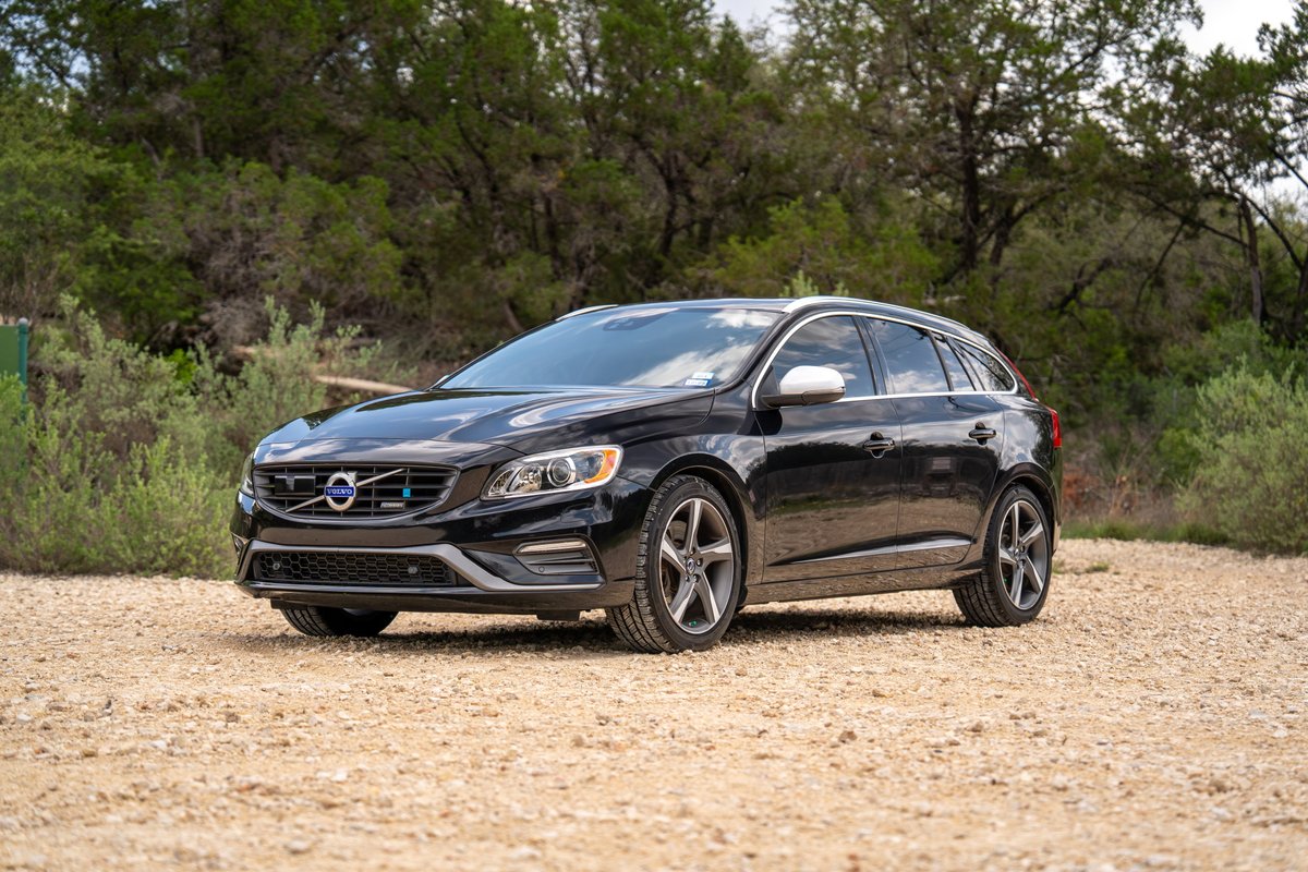 Black 2015 Volvo V60 R-Design Polestar with silver rims and trim.