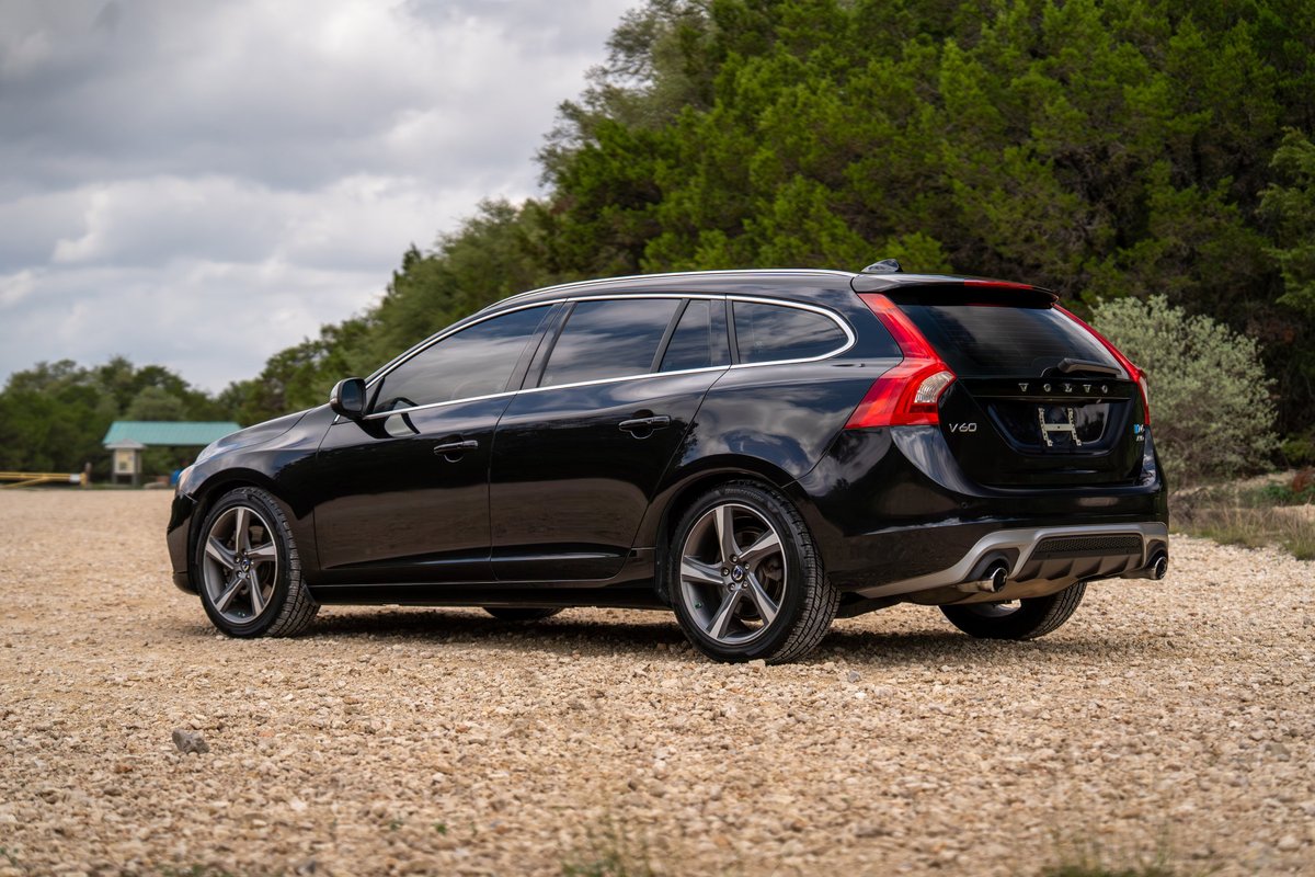 Black 2015 Volvo V60 R-Design Polestar with dual exhaust tips and silver alloy rims.