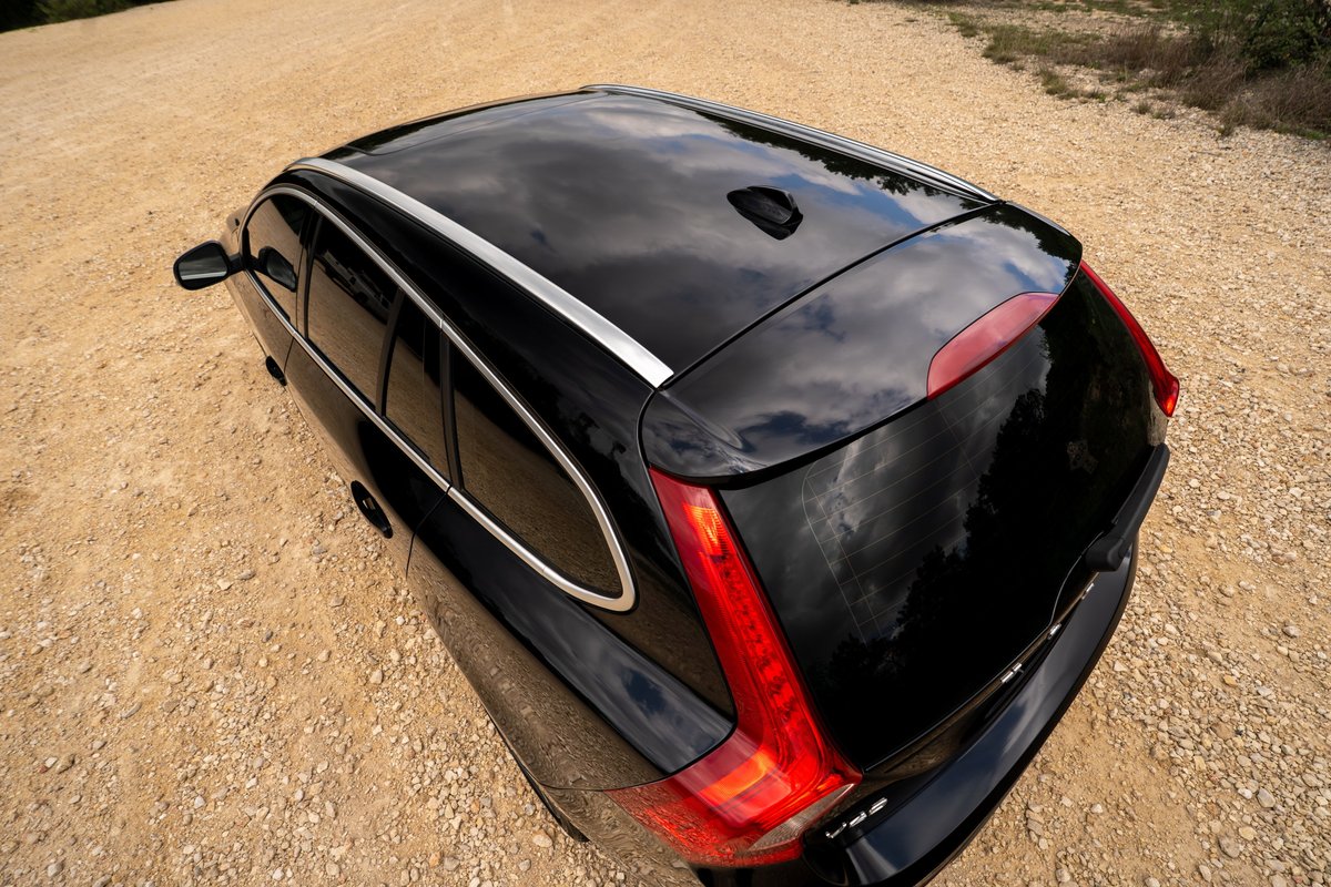 Overhead shot of a black 2015 Volvo V60 R-Design Polestar with chrome window trim and roof rails.