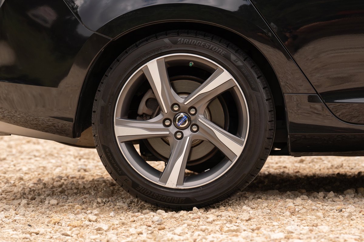 Black 2015 Volvo V60 R-Design Polestar with gray alloy rims and Bridgestone tires.