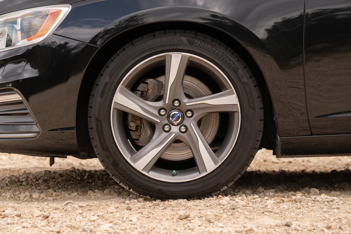 Black 2015 Volvo V60 R-Design Polestar with alloy rims and Bridgestone tires.