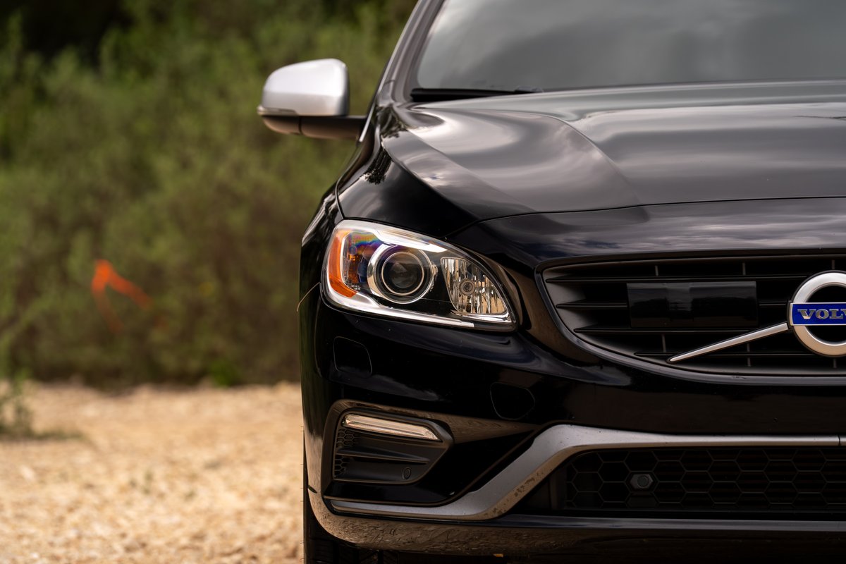 Black 2015 Volvo V60 R-Design Polestar. Front driver's side headlight and grille detail.