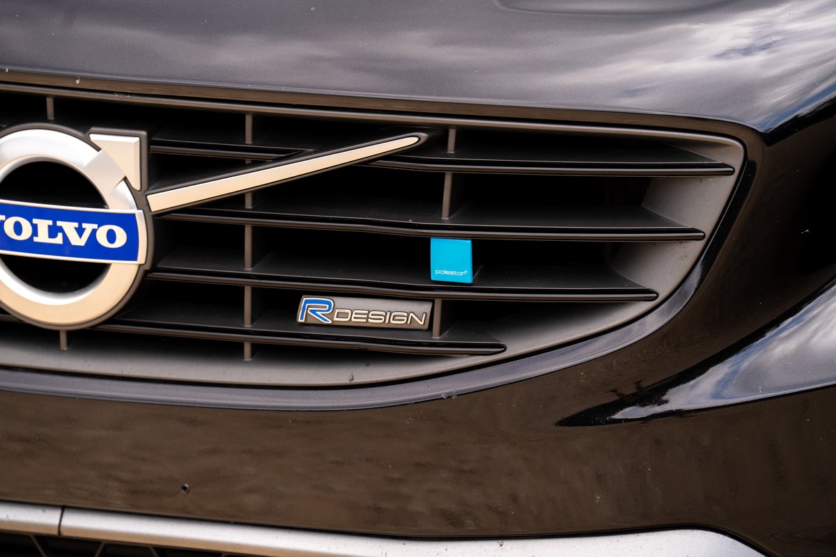Black Volvo V60 R-Design grille with "R" badge and blue accent.