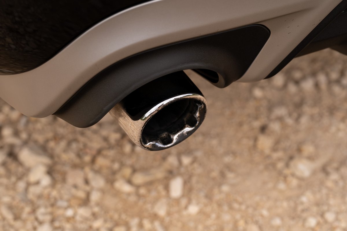 Close-up of a chrome exhaust tip with sculpted trim on a 2015 Volvo V60 R-Design Polestar.
