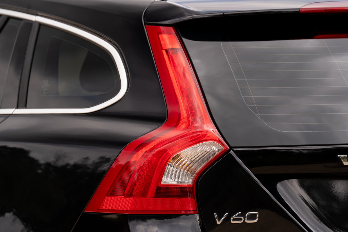 Close-up of a black 2015 Volvo V60 R-Design Polestar's vertical LED taillight and V60 badging.