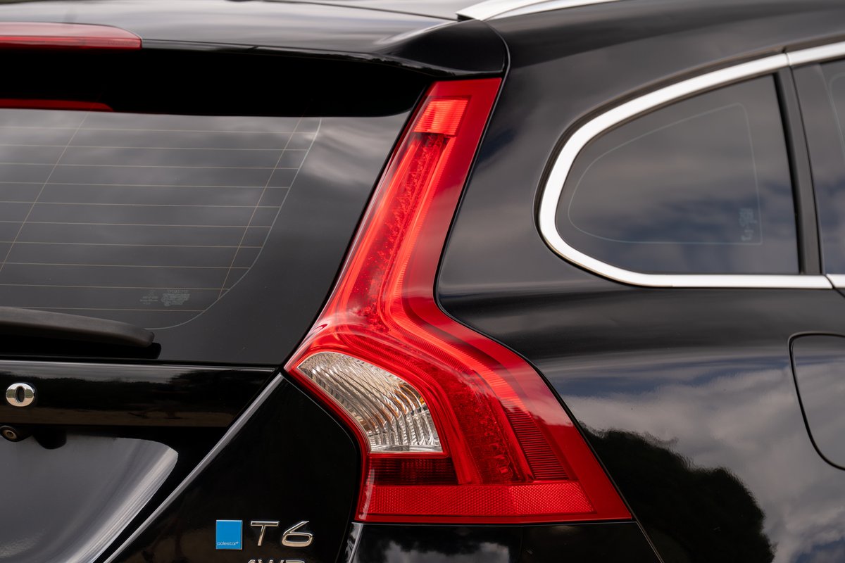 Black 2015 Volvo V60 R-Design Polestar T6 AWD taillight and chrome window trim.