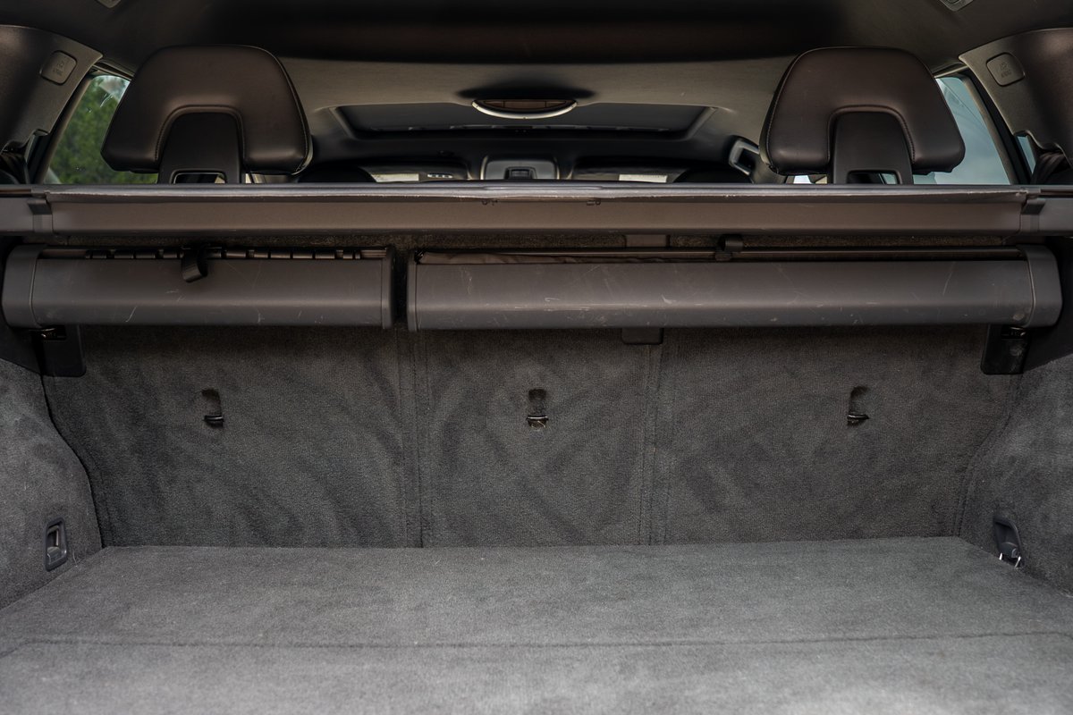 Interior of a 2015 Volvo V60 R-Design Polestar showing the carpeted trunk with cargo cover.
