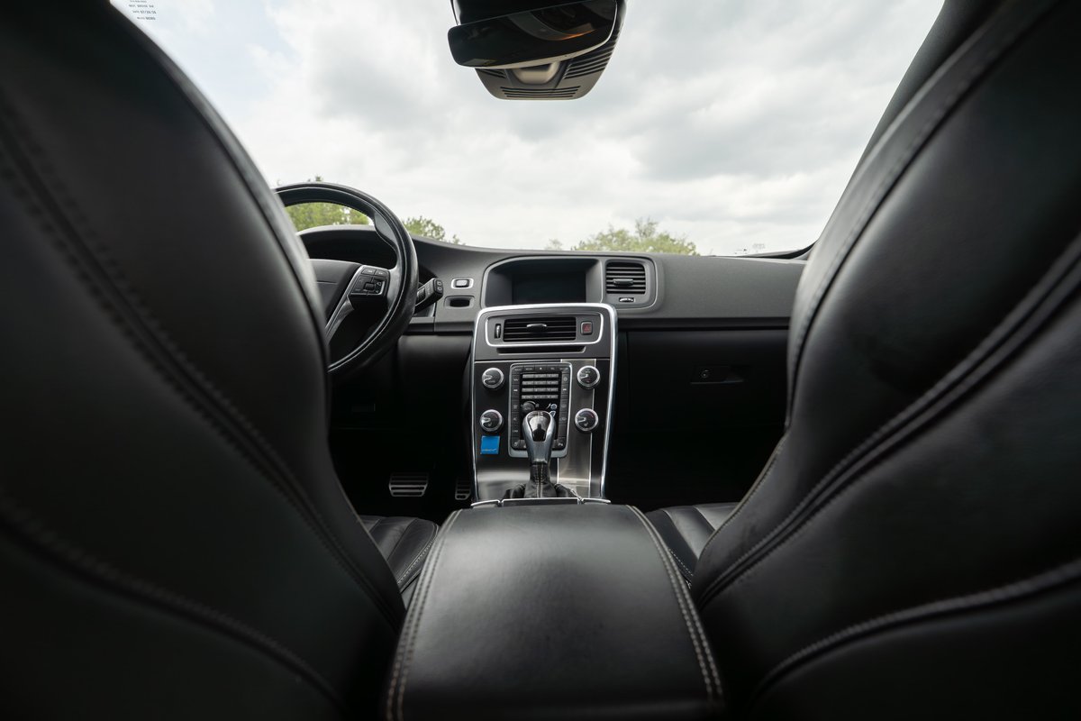 Interior view of a black 2015 Volvo V60 R-Design Polestar, showing leather seats and dashboard.