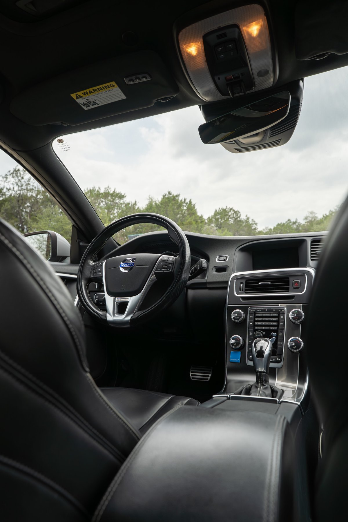 2015 Volvo V60 R-Design Polestar interior. Black leather seats, chrome trim, and multimedia system.